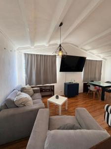 a living room with a couch and a table at Soul Home in Momoxpan