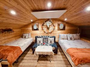 a room with two beds and a couch and a table at Cosy Cabin - Near Belfast International Airport in Aldergrove