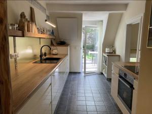 a kitchen with a sink and a counter top at Das Mosel Ferienhaus in Zell an der Mosel +21 photos