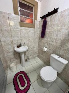 a bathroom with a toilet and a sink at Casa da Mata in Ubatuba +11 photos