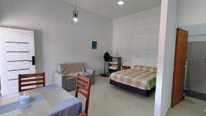 a bedroom with a table and a bed and a table and chairs at Viva apart in Fiambalá