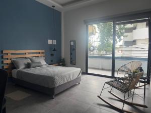 a bedroom with a bed and a chair at Living Sincelejo in Sincelejo