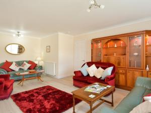 a living room with two couches and a table at Westburn in Comrie