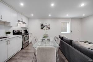 a kitchen and living room with a table and a couch at Modern 2Bed Suite Near Capilano Bridge & Trails in North Vancouver +21 photos