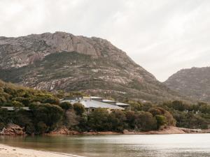 a house on the shore of a river with a mountain at Freycinet Lodge in Coles Bay +32 photos