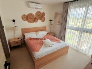 a bedroom with a bed and a large window at Punta Cana with Private Jacuzzi in Punta Cana +64 photos