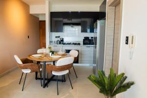 a dining room with a table and chairs and a kitchen at Punta Cana with Private Jacuzzi in Punta Cana