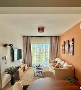 a living room with a couch and a tv at Punta Cana with Private Jacuzzi in Punta Cana