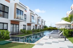 an exterior view of a building with a swimming pool at Punta Cana with Private Jacuzzi in Punta Cana