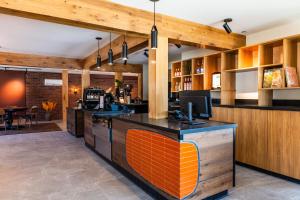 a kitchen with an orange and black counter top at Boundary Hotel By Terra Vi, Durango in Durango