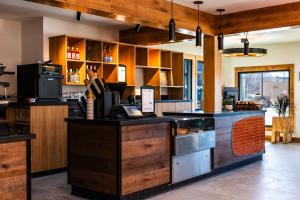 a kitchen with wooden cabinets and a counter top at Boundary Hotel By Terra Vi, Durango in Durango +12 photos