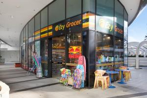 a store with colorful chairs and tables in front of it at Golden Arcade - Views Games Vibes in Gold Coast
