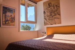 a bedroom with a bed and two windows at Chalet di design vista Pelmo - Chalet dei Brisi in Borca di Cadore