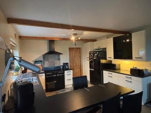 a kitchen with a table and a stove top oven at Skellig Sanctuary in Dingle