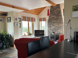 a living room with a table and chairs and a fireplace at Skellig Sanctuary in Dingle