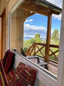 a window in a train looking out at a view at Andalue in San Carlos de Bariloche