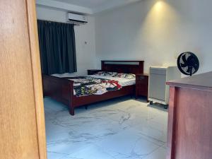 a bedroom with a bed in a room with at Tranquil Stay Tunereng in Tujering