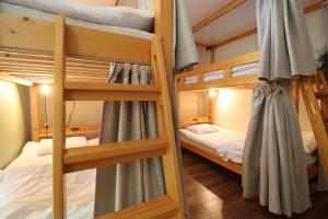 a bunk bed room with two bunk beds at SWELL in Hyuga