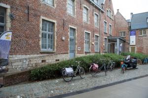 a group of bikes parked in front of a brick building at Irish College Leuven in Leuven
