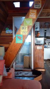 a room with a staircase with signs on it at Chalé toca do tigre in Ponta Grossa