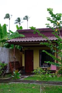a small yellow house with a red roof at Sonya Kohlanta in Ko Lanta