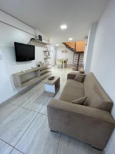 a living room with a couch and a flat screen tv at Karina Apartamentos in La Rioja