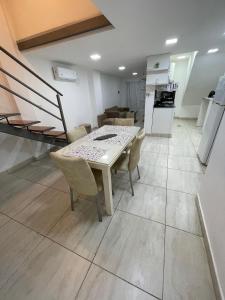 a kitchen and dining room with a table and chairs at Karina Apartamentos in La Rioja