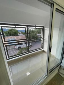 a room with a window with a view of a yard at Karina Apartamentos in La Rioja