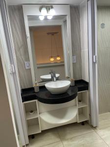 a bathroom with a sink and a mirror at Karina Apartamentos in La Rioja +30 photos