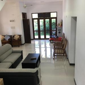 a living room with a couch and chairs at Bosadi Hotel katunayake in Katunayaka
