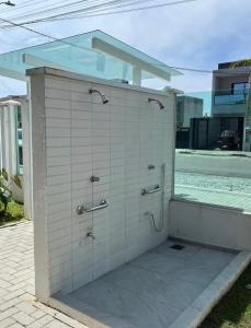 a bathroom with three shower stalls in a building at Estúdio Fit Caiobá - Matinhos in Matinhos