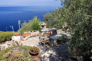 a garden with a stone fireplace and the ocean at Apartments by the sea Prigradica, Korcula - 543 in Blato +19 photos