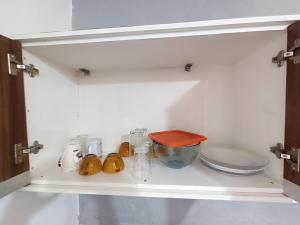 a drawer in a refrigerator filled with food items at Loft D Mobiliado, individual com ar condicionado e garagem privada in Dourados +13 photos