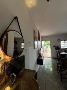 a bathroom with a sink and a mirror on the wall at Loft D Mobiliado, individual com ar condicionado e garagem privada in Dourados