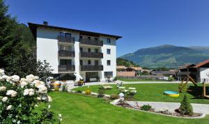 a building with a yard with a playground at Suvendes Apartments in Prato allo Stelvio