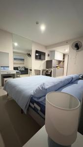 a large bedroom with a large bed with a chair at Jtower Residences Rad Staycation in SM Jmall in Mandaue City