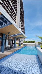 a swimming pool in front of a building at Jtower Residences Rad Staycation in SM Jmall in Mandaue City