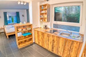 a kitchen with wooden cabinets and a sink and a window at Seaside-Townhouse in Timmendorfer Strand +177 photos