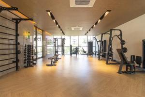 a gym with a lot of treadmills and machines at Studio Lumière Moema in São Paulo