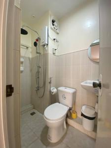 a small bathroom with a toilet and a shower at Las Fallas Staycation in Santa Rosa