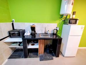 a small kitchen with a sink and a refrigerator at Dptos Ceci in Centenario