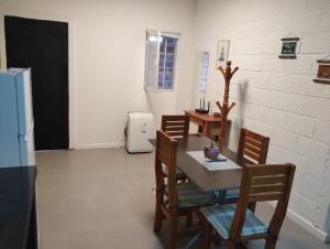 a dining room with a table and chairs and a refrigerator at Dptos Ceci in Centenario +3 photos
