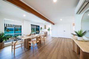 a dining room with a table and chairs at Broadwater Breeze in Airlie Beach