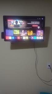 a flat screen tv hanging on a wall at Studio Figueira, Flor in Santarém