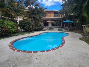 a swimming pool in front of a house at Casa Las Brisas in Nicoya