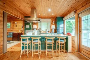 a kitchen with a large island with bar stools at Juden Fuji168 山中湖湖畔 高級ログハウス 135平米四寝室 in Yamanakako