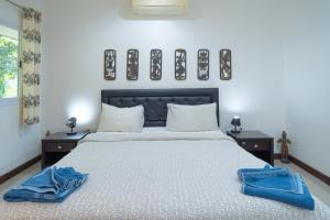 a bedroom with a bed with two blue towels on it at JUNGLE APARTMENT2 BEDROOMS PRIVATE POOl in Kamala Beach