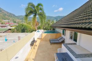 a balcony of a house with a swimming pool at JUNGLE APARTMENT2 BEDROOMS PRIVATE POOl in Kamala Beach