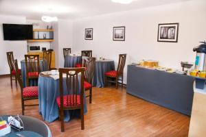 a restaurant with blue tables and chairs and a counter at Hoteles Riviera Cayma in Arequipa