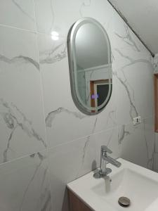 a bathroom with a sink and a mirror at Casa Jesy in Frutillar